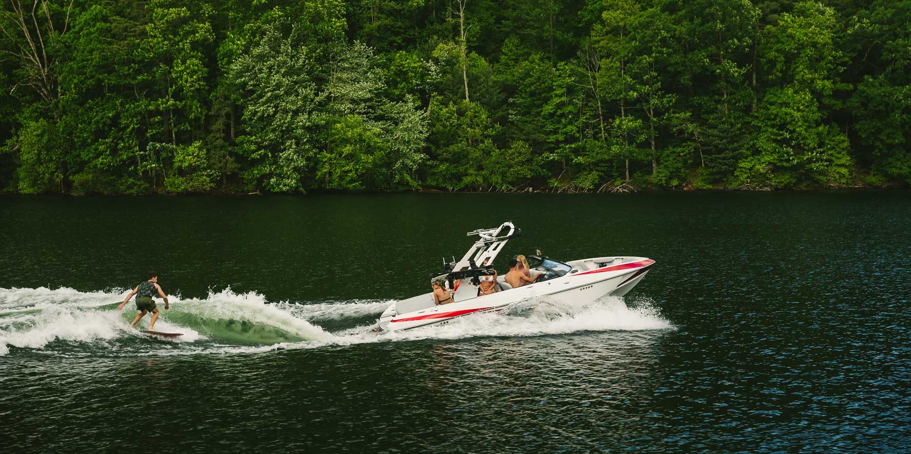 Surfing behind the Malibu Boats 21 VLX