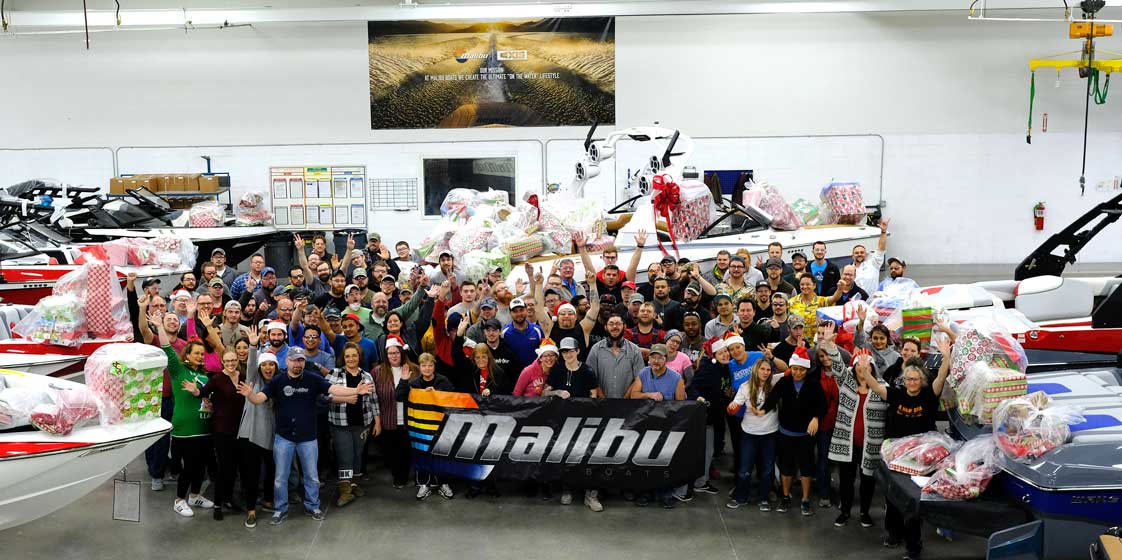 Employees gathered around the Malibu banner