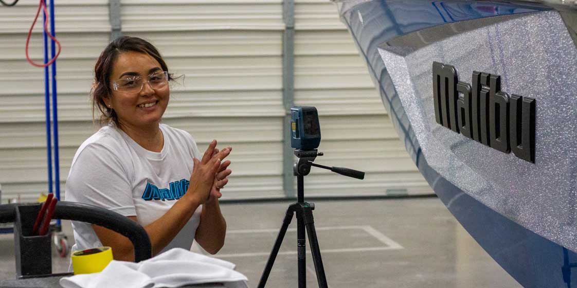 Employee checking alignment of the hull.