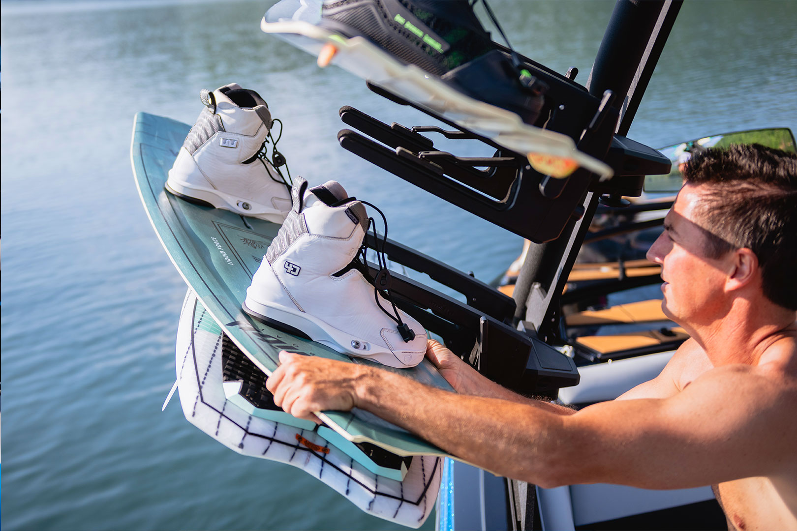 Rider Placing Wakeboard on Board Rack of Tower of Axis T250