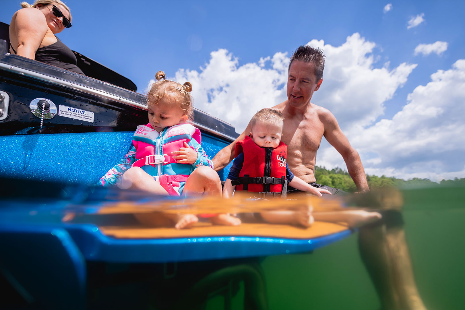 Dad and Two Kids Sitting on Swim Step Platform of Axis T250