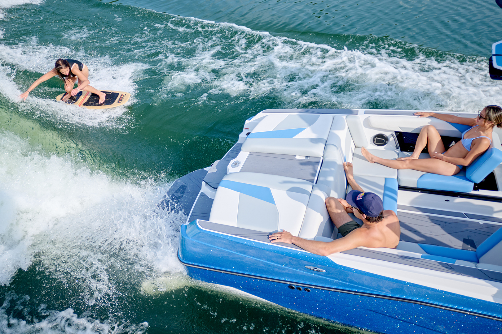 Close-up of the Axis T250 stern with a clean surf wave behind the boat and Surf Gate® in action.