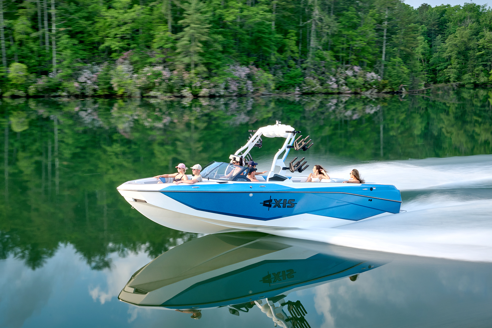 Front view of the Axis T250 driving down the lake, highlighting the traditional bow and gel coat styling.