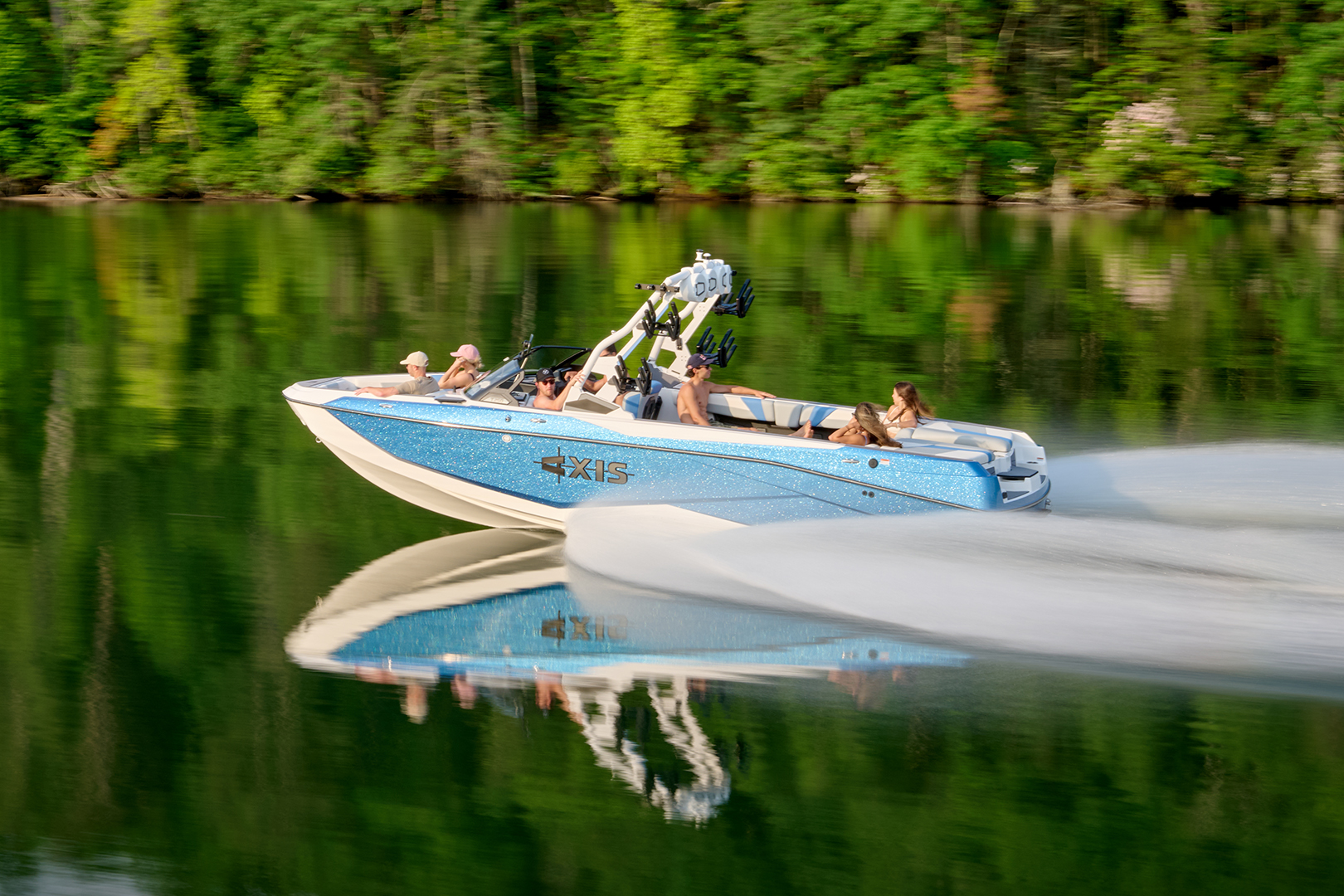 Side view of Axis T250 running on the lake with sunlight reflecting off the gel coat and exterior finish.