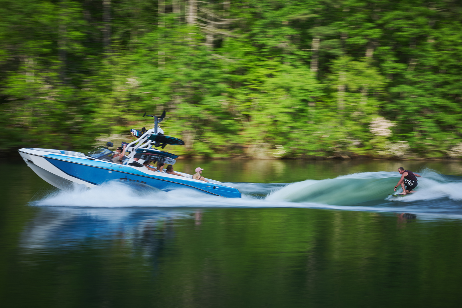 Portside action shot of Johnny Stieg surfing a super clean, well-shaped wave behind the Axis T250.