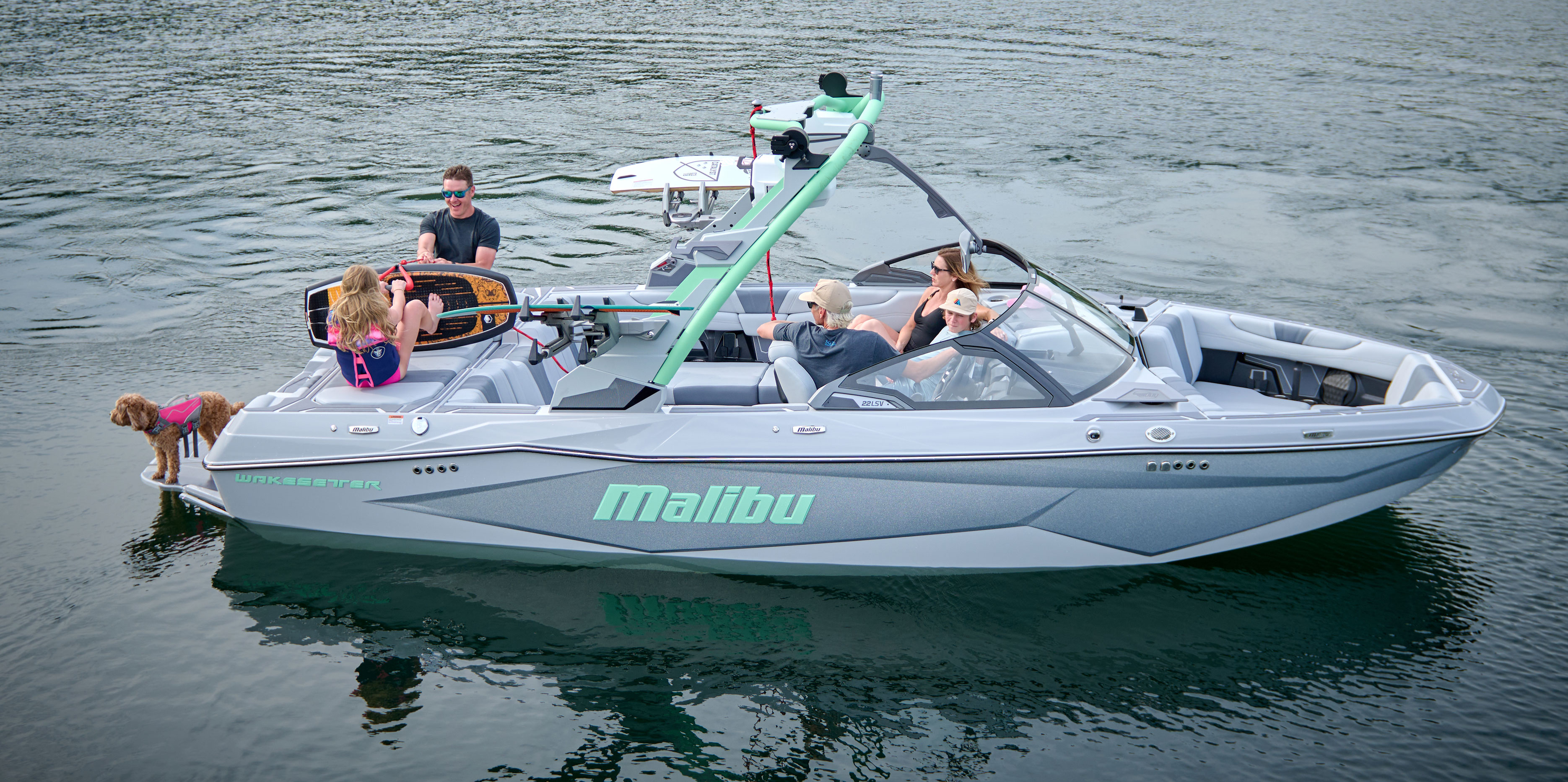 Rear view of the Malibu Wakesetter 22 LSV with passengers lounging at the transom and enjoying the Flip Down Swim Step.