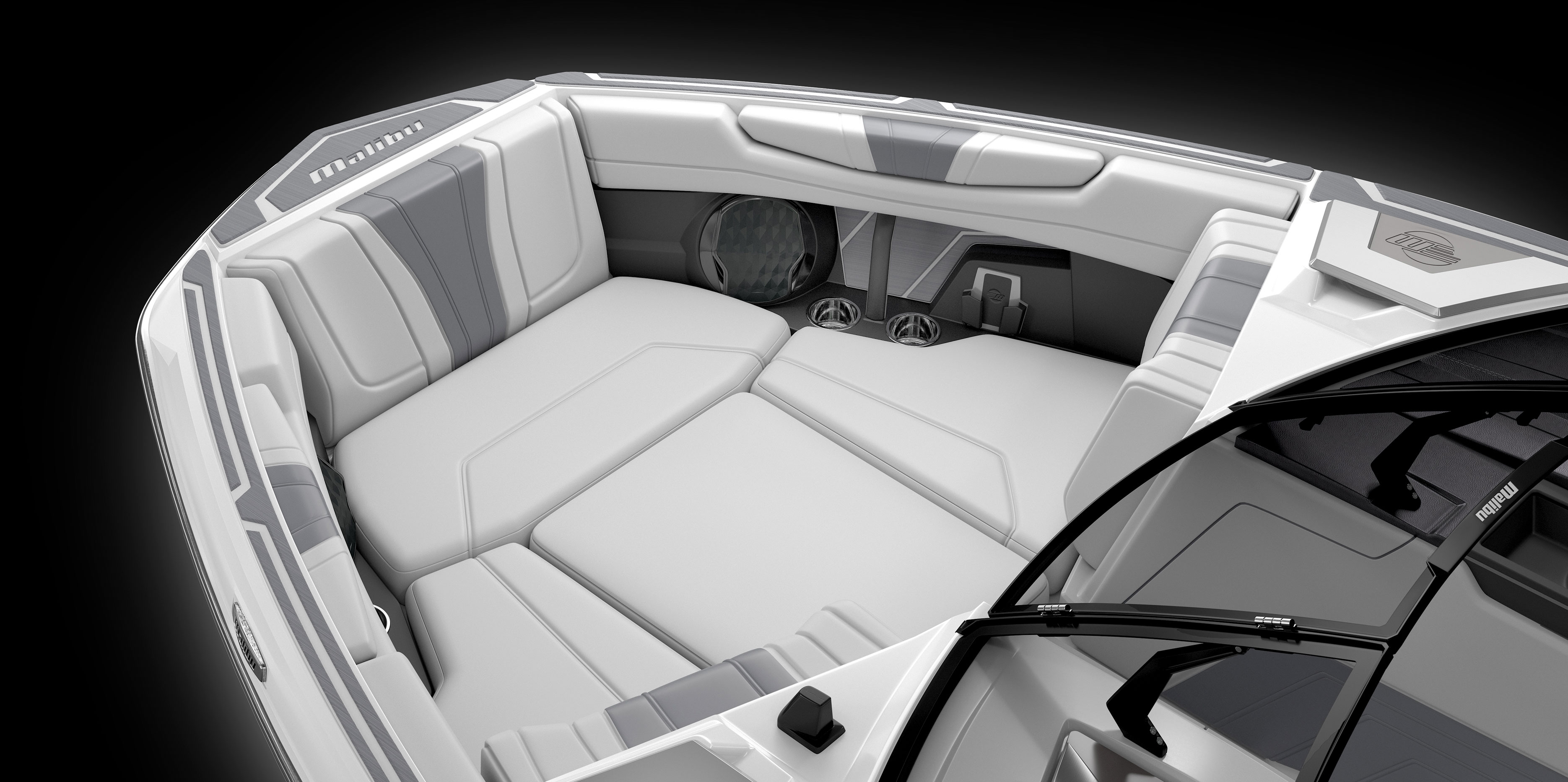 Interior view of the Malibu Wakesetter 22 LSV showcasing spacious lounge seating, plush upholstery, and storage compartments.