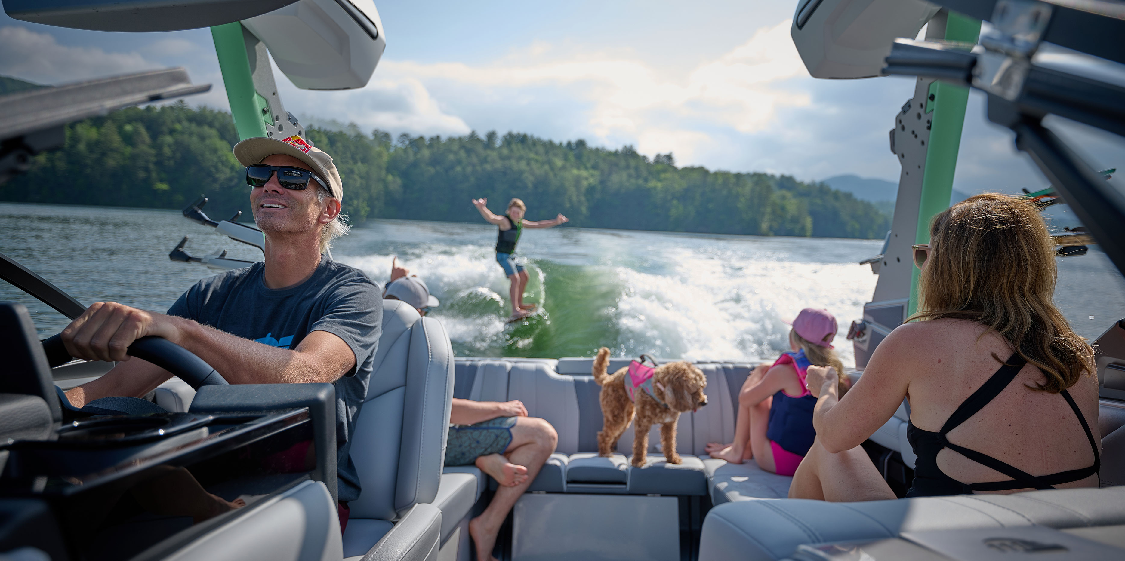 Close-up action shot of a wakesurfer riding a powerful, well-shaped wave behind the Malibu Wakesetter 22 LSV.