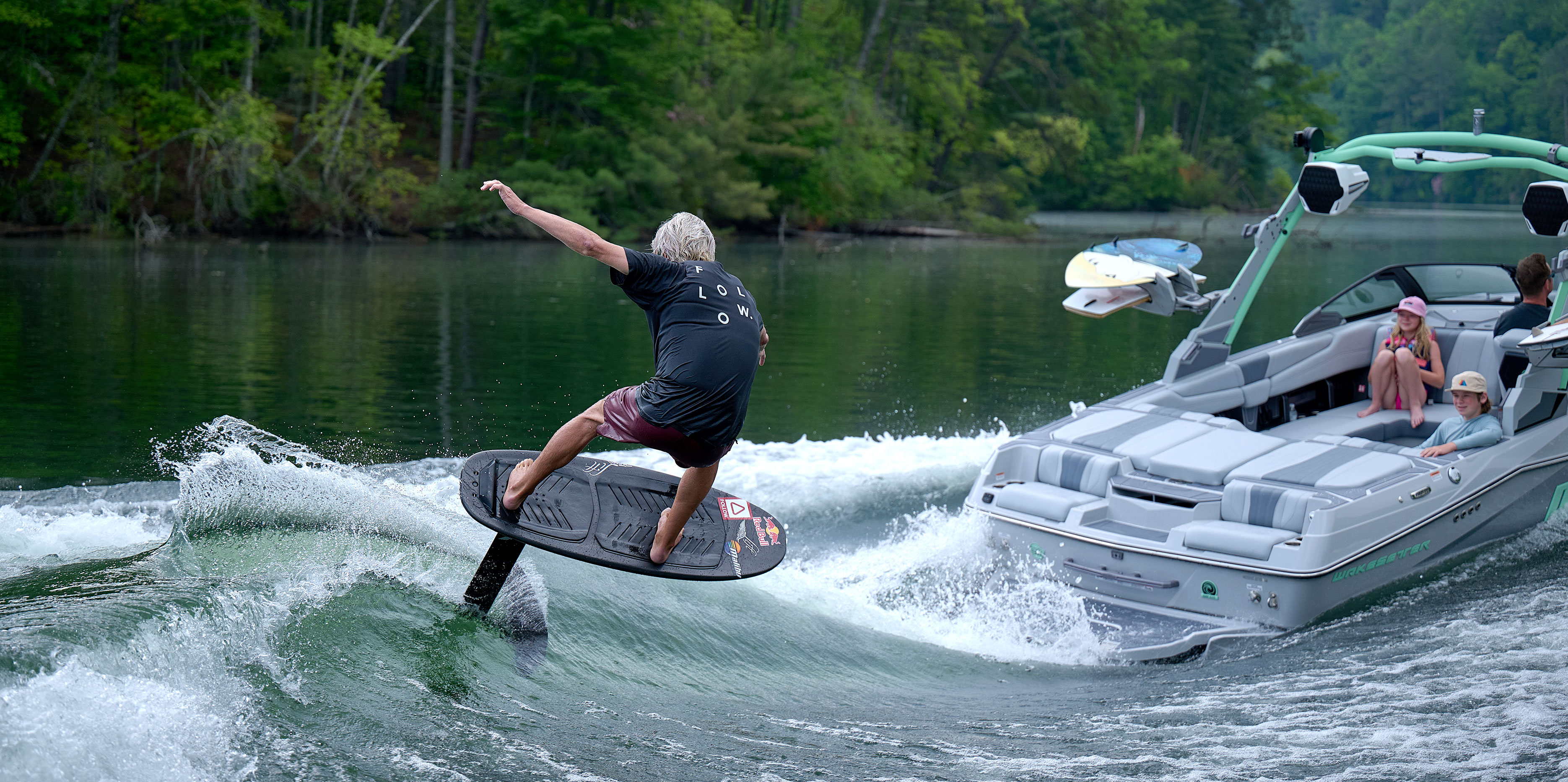 Wakesurfer gliding down the face of a clean wave behind the Malibu Wakesetter 22 LSV in action.